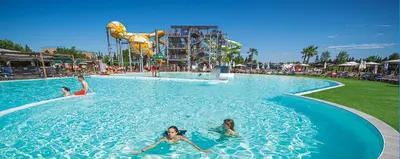 a group of people swimming in a pool at a water park at Appartement climatisé avec cour en centre ville in Carpentras