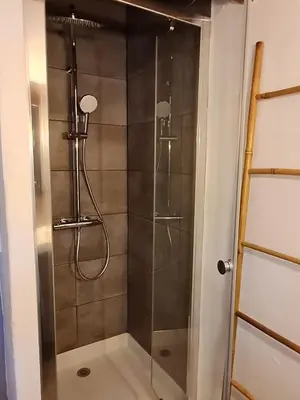 a shower with a glass door in a bathroom at Lumineux Duplex au coeur de l'Isle in LʼIsle-sur-la-Sorgue