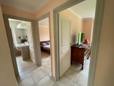 a room with a hallway with a door and a bathroom at BASTIDE DU DEFENDS in Pertuis