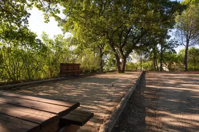 a park with benches and trees in a park at BASTIDE DU DEFENDS in Pertuis