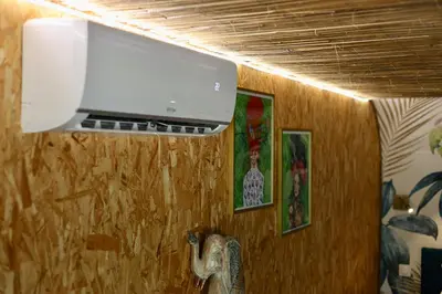 a tv hanging on a wall in a room at Mas des muses in LʼIsle-sur-la-Sorgue