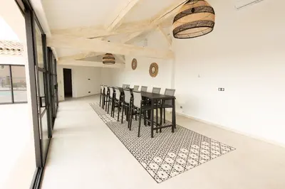 a dining room with a black table and chairs at MAISON LAVANDE du MAS LOU CAPY in Salon-de-Provence