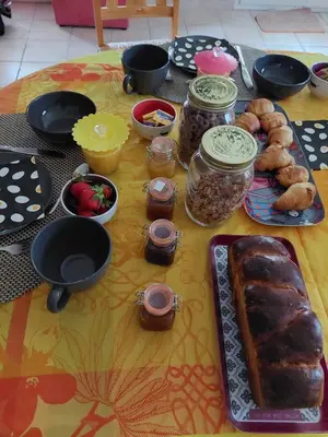 a table with a table cloth with food on it at Maison jaune in Villemus