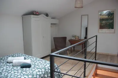 a bedroom with a bed and a staircase in it at MAS-Calou in Coustellet