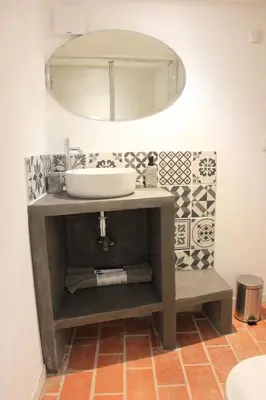 a bathroom with a sink and a mirror at MAS-Calou in Coustellet