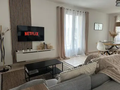 a living room with a couch and a tv at Une maison en Provence in Pierrevert