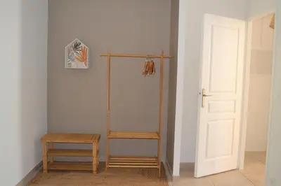 a room with a towel rack and a stool and a door at Une maison en Provence in Pierrevert