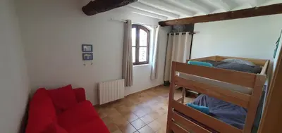a room with two bunk beds and a couch at Appartement 3P Lubéron in Viens
