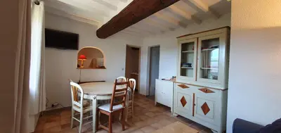 a kitchen and dining room with a table and chairs at Appartement 3P Lubéron in Viens