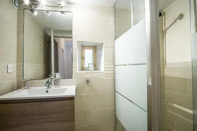 a bathroom with a sink and a mirror at Maison avec jardin proche du centre-ville Isle-sur-la-Sorgue in LʼIsle-sur-la-Sorgue