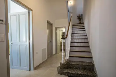 a hallway with a stairway with a door and a stair case at Maison avec jardin proche du centre-ville Isle-sur-la-Sorgue in LʼIsle-sur-la-Sorgue