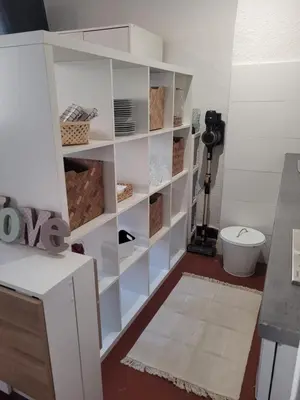 a white book shelf in a room with a toilet at Aix-en-Provence Superbe studio centre historique in Aix-en-Provence