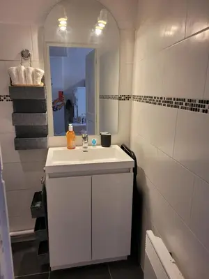 a bathroom with a white sink and a mirror at Aix-en-Provence Superbe studio centre historique in Aix-en-Provence