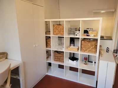 a kitchen with a white cabinet with shelves at Aix-en-Provence Superbe studio centre historique in Aix-en-Provence