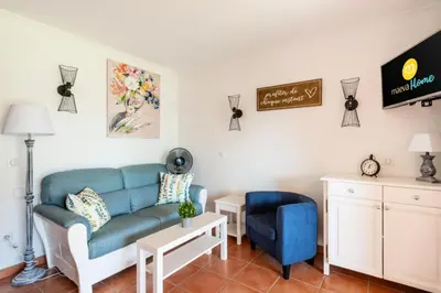 a living room with a blue couch and a chair at Village Pont Royal en Provence - maeva Home - Appartement décoré avec goût et climatisé 2 pièces 5 personnes - Prestige - super Home MAE-1144 in Mallemort