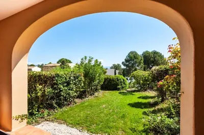 a view of a garden through an archway at Village Pont Royal en Provence - maeva Home - Appartement décoré avec goût et climatisé 2 pièces 5 personnes - Prestige - super Home MAE-1144 in Mallemort