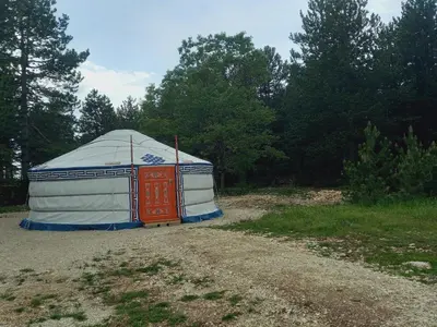 a yurt sitting on a dirt road in a field at A Ventoux Yourte in Monieux