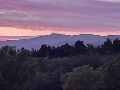 a view of a mountain with a lighthouse on top at A Ventoux Yourte in Monieux