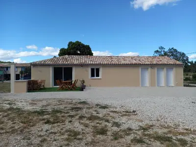 a house with a table and chairs in front of it at A Ventoux Yourte in Monieux