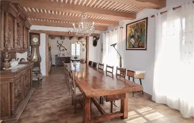 a dining room with a large wooden table and chairs at 3 Bedroom Amazing Home In Lagnes in Lagnes