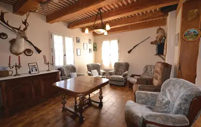 a living room with a table and chairs at 3 Bedroom Amazing Home In Lagnes in Lagnes