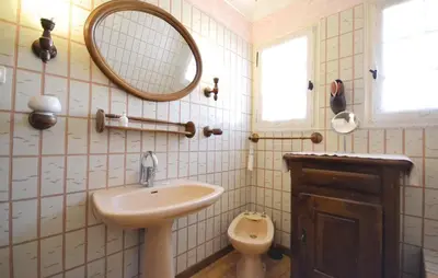 a bathroom with a sink and a mirror and a toilet at 3 Bedroom Amazing Home In Lagnes in Lagnes