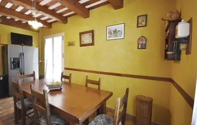 a dining room with a wooden table and chairs at 3 Bedroom Amazing Home In Lagnes in Lagnes