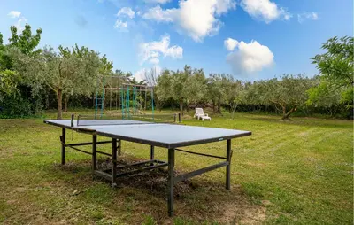 a ping pong table in the middle of a field at Beautiful Home In Lauris With Wifi in Lauris