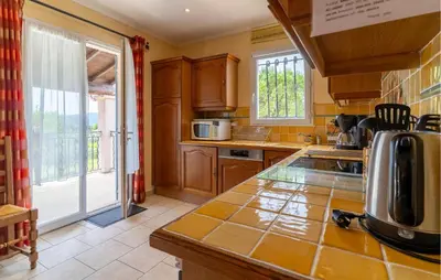 a kitchen with wooden cabinets and a counter top at Beautiful Home In Lauris With Wifi in Lauris