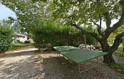 a green ping pong table under a tree at 3 Bedroom Nice Home In Mazan in Mazan