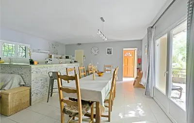 a kitchen and dining room with a table and chairs at 3 Bedroom Nice Home In Mazan in Mazan