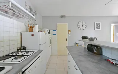 a kitchen with a stove and a white refrigerator at 3 Bedroom Nice Home In Mazan in Mazan