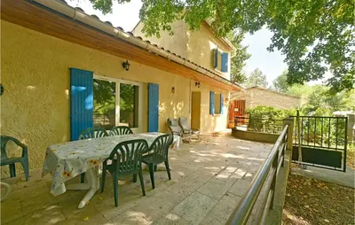 a patio with a table and chairs on a balcony at 3 Bedroom Nice Home In Mazan in Mazan