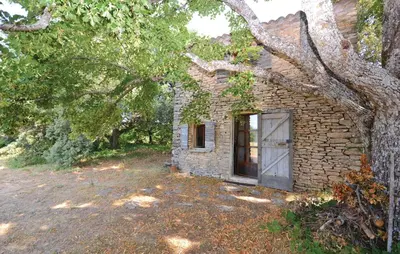 an old stone house with a door in a yard at 1 Bedroom Beautiful Home In Saignon in Saignon