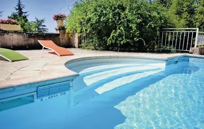 a swimming pool in a yard with a chair and a table and a chair at 3 Bedroom Cozy Home In Sault in Sault-de-Vaucluse