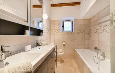a bathroom with a sink and a tub and a toilet at 3 Bedroom Cozy Home In Sault in Sault-de-Vaucluse