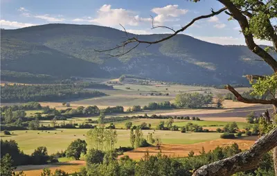 a view of a field with mountains in the background at 3 Bedroom Cozy Home In Sault in Sault-de-Vaucluse