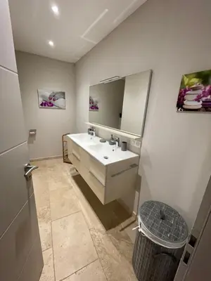a bathroom with a sink and a mirror at Petite maison près du centre in LʼIsle-sur-la-Sorgue