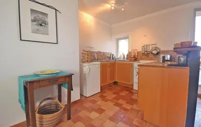 a kitchen with a counter and a table in it at Cozy Apartment In Bonnieux With Kitchen in Bonnieux