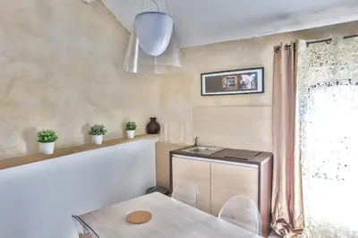 a kitchen with a table and a sink and a window at Apartments - Experience of PROVENCE in Gordes