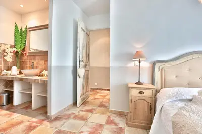a bathroom with a sink and a bed in a room at Apartments - Experience of PROVENCE in Gordes