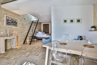 a living room with a fireplace and a table and chairs at Apartments - Experience of PROVENCE in Gordes