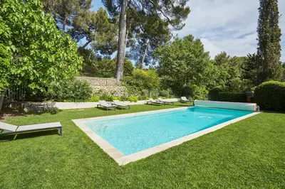 a swimming pool in the yard of a house at Exclusif Appart piscine chauffée de luxe 10 min centre AixenPc Belvoir SISSI in Aix-en-Provence