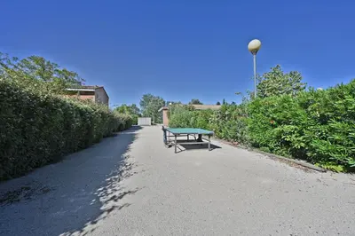 a bench sitting on the side of a path at LE PETIT BONHEUR - PLACE PARKING PRIVEE - CLiM - TERRASSE - PISCINE PARTAGEE - PROCHE PARC SPIROU in Saint-Saturnin-les-Avignon