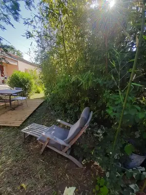 a lounge chair and a table in a yard at Villa 