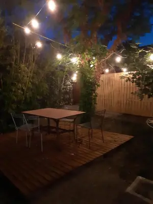a table and chairs in a backyard at night at Villa 