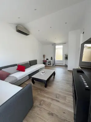 a living room with a couch and a table at Villa Provençale avec Piscine Chauffée in Saint-Andiol