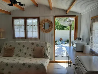 a living room with a couch and a table at Chalet au pied du Mont Ventoux in Mormoiron
