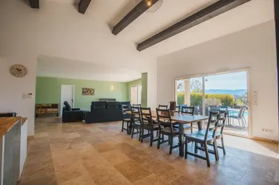 a living room with a table and chairs at LE PETIT CHENE in Apt