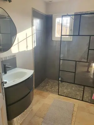 a bathroom with a tub and a glass shower at Villa L'Estagniol in Lourmarin